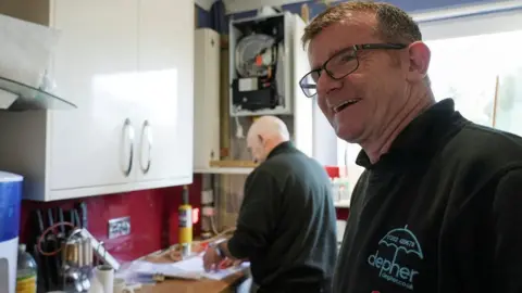 Reuters James Anderson and a plumber at work