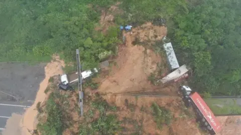 Reuters An aerial view shows a landslide in BR-376 federal road after heavy rains in Guaratuba, Parana state, Brazil November 29, 2022.