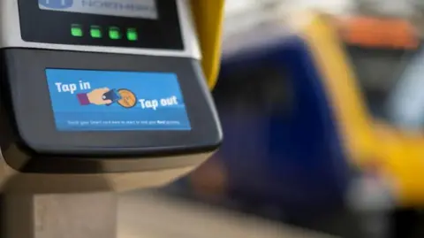 Ticket machine with a screen which says Tap in Tap out on blue background