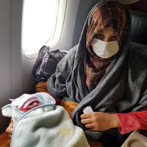 Reuters Afghan evacuee Soman Noori holds her newborn baby girl named Havva on board an evacuation flight operated by Turkish Airlines from Dubai to Britain"s Birmingham, August 28, 2021