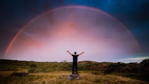 Gareth Mon Jones Red rainbow in imposing sky over Anglesey captured by Gareth Mon Jones.