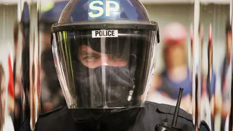 Getty Images Police officer in riot helmet