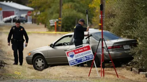 Getty Images Police examine a vehicle that was involved in the string of shootings in Rancho Tehama