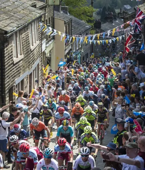 Danny Lawson/PA Wire Cyclists ride through Haworth, Tour de Yorkshire 2018