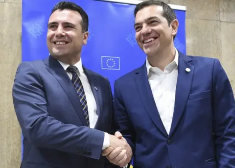 EPA Alexis Tsipras and Zoran Zaev pictured smiling and shaking hands on the sidelines of an informal EU summit