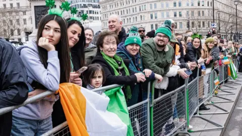 SOPA Images Onlookers wait for the parades at 2023's edition