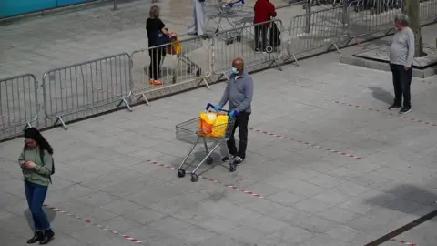 Reuters Queue to get into supermarket