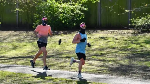 Reuters People wearing a mask run in Battersea Park on Sunday 5 April