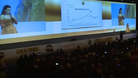 OneCoin/Youtube Dr Ruja on the stage at a 2015 OneCoin event in Dubai