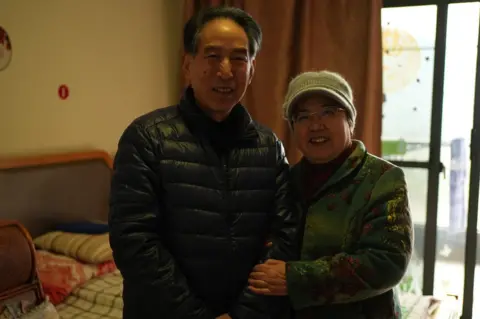 Xiqing Wang/ BBC The Fengs in their room at the Sunshine Care Home