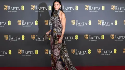 EPA Demi Moore poses on the red carpet at the 2025 EE BAFTA Film Awards at the Royal Festival Hall in London, Britain