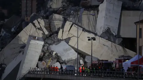 AFP/Getty Rescuers search for survivors of the Genoa road bridge collapse August 2018