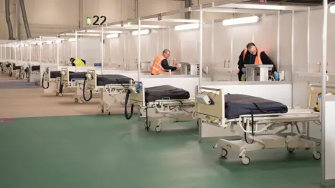 Reuters Contractors work at ExCel London while it was converted into the temporary NHS Nightingale Hospital