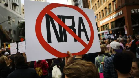 Getty Images A protester hold an anti-NRA sign at the 2018 March for Our Lives protest in Los Angeles