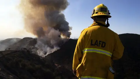 EPA A firefighter looks at the Getty Fire