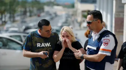 Reuters Woman comforted after rocket attack in Ashkelon