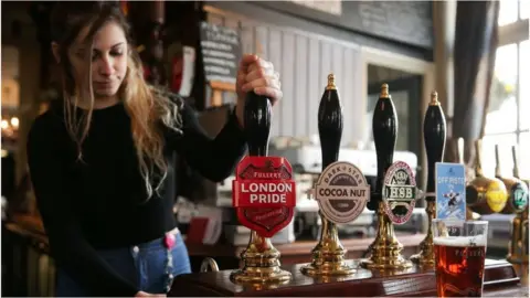 Getty Images woman pouring pint