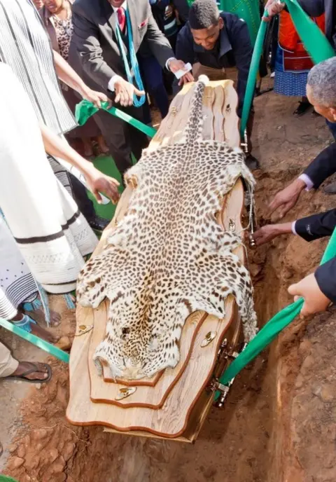AFP A coffin containing the remains of the former leader of the Khoi people, David Stuurman, is lowered into the ground