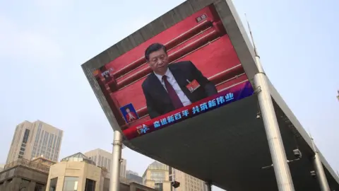 EPA A large screen displays Chinese President Xi Jinping attending the closing session of the National People's Congress (NPC), in Beijing, China, 11 March 2021