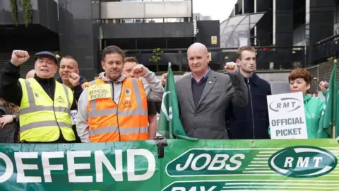 PA Media Mick Lynch joins members of his union on Saturday outside Euston station