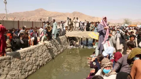 EPA Afghans outside the airport before the blast