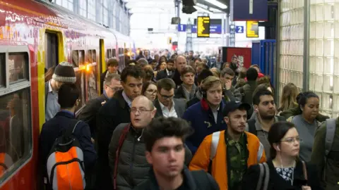 AFP/Getty Rail passengers at Waterloo