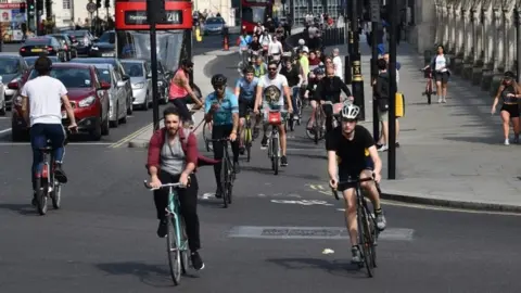 AFP People cycling through London