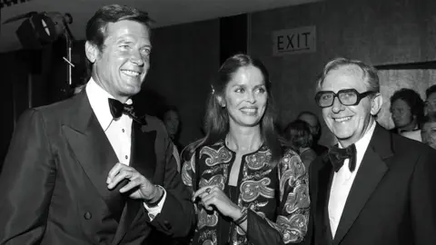 Harry Myers/REX/Shutterstock Lewis Gilbert with Roger Moore and Barbara Bach in 1977