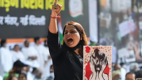 MONEY SHARMA/ Getty Images Woman protesting violence against women