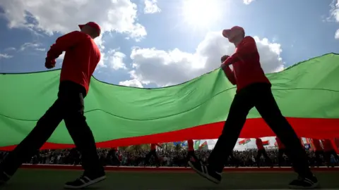 Getty Images People carry a Belarus flag