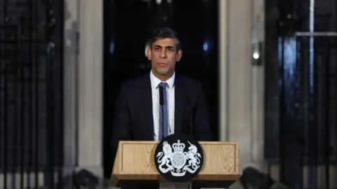 EPA Prime Minister Rishi Sunak standing at a lectern outside 10 Downing Street