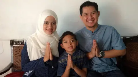 Novita Purwanti Novita a nurse with her son and husband.