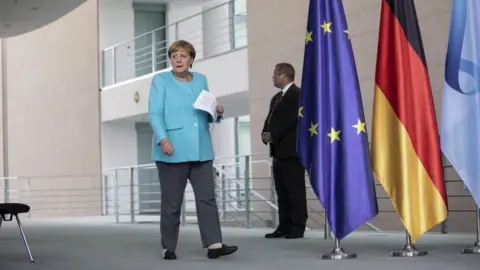 EPA German Chancellor Angela Merkel (L) arrives to speaks to the media following a virtual meeting of the European Council, during the coronavirus pandemic in Berlin, Germany, 19 August 2020.
