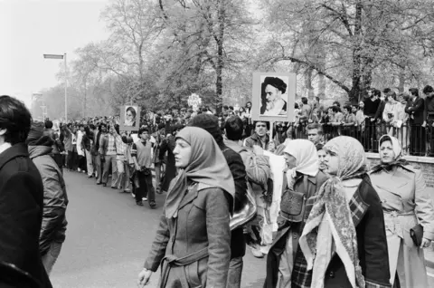 Kent Gavin/Daily Mirror/Mirrorpix/Getty Images Supporters of the Ayatollah Khomeini marching near the embassy, 1 May 1980.