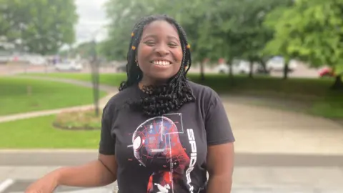 Jada is smiling into the camera. She is wearing a spiderman t-shirt