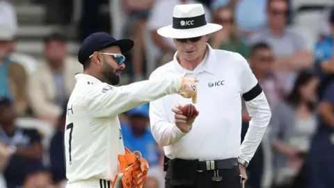 India wicketkeeper Rishabh Pant pleads his case to umpire Paul Reiffel about the condition of the ball on day three of the first Test