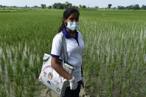 VSO/P Mathema Muni Kumari Gupta standing in a field