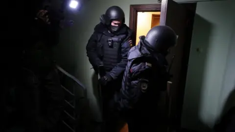 EPA Policemen leave the flat of opposition leader Alexei Navalny in Moscow, Russia, 27 January 2021