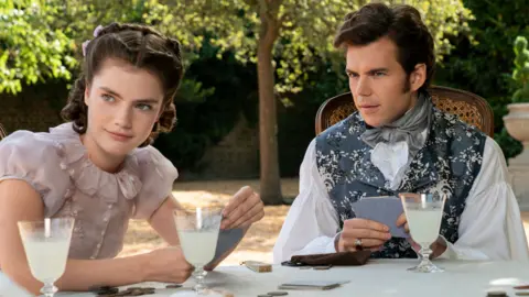 Netflix (L to R) Florence Hunt as Hyacinth Bridgerton, Luke Newton as Colin Bridgerton