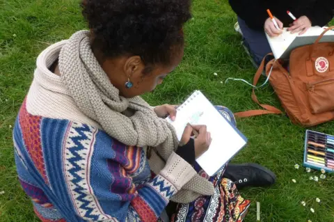 Avon Gorge and Downs Wildlife Project Jasmine Ibrahim sits drawing in a pad