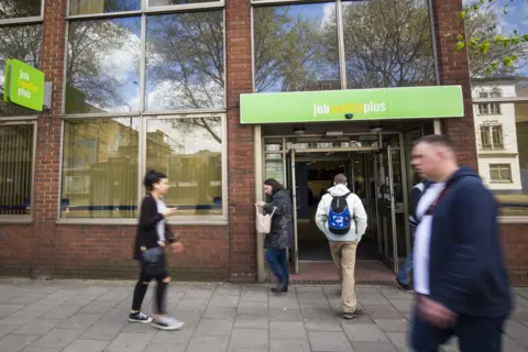 Getty Images Picture of people entering a job centre