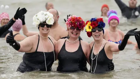 PA Media Gosport swimmers in fancy dress on New Year's Day