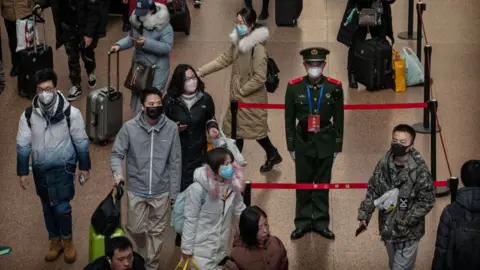 Getty Images A Chinese police officer at a Beijing railway station.