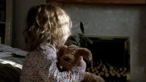 BBC Girl holding teddy bear