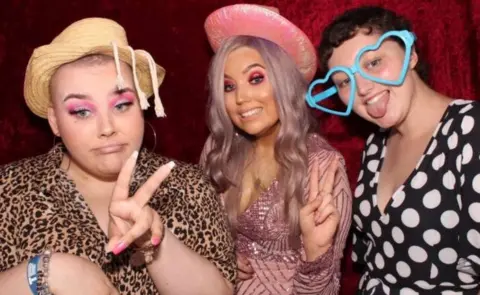 Teenage Cancer Trust Charlie Aldred, Sophie Wheldon and Georgina Haywood (left to right) pictured in a photo booth for Ms Wheldon's 21st birthday