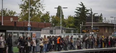 Getty Images Passengers on a platform