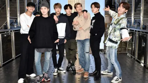 Getty Images V, Suga, Jin, Jungkook, RM, Jimin, and J-Hope of the K-Pop Group BTS visit The Empire State Building on May 21, 2019