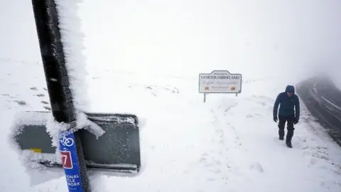 PA Media Man walking into Cumbria from Northumberland