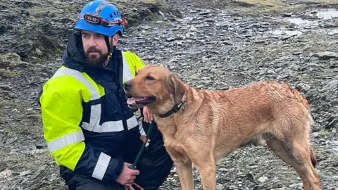 Port Erin Coastguard Rum the dog with a member of the coastguard rescue team