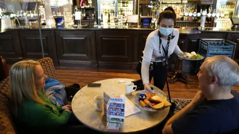 Owen Humphreys / PA Media Customers inside the Mile Castle pub i